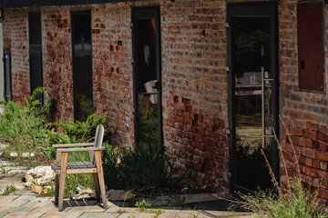 old wooden chair next to the abandoned building