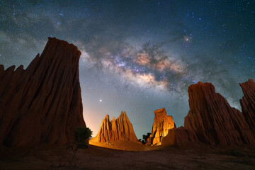 Wall Mural - Beautiful milky way raised over natural earth pillar in various shapes crafted by soil erosion in Lalu, Sakaeo, Thailand