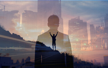 young confident business man facing the city view. man celebrating on a mountain top. people vision 