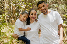 Hispanic Parents With Their Daughter In The Park - Happy Little Family - Young Parents
