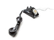 Old Late 60s - 70s style black telephone with rotary dial. Isolated on white. Hand set off the hook and unattended.  