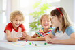 © famveldman - Family playing board game. Kids play.