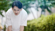 © aijiro - 屋外で暑がる若い男性