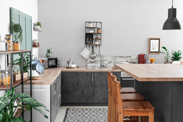 Cooking utensils and products on table in interior of modern kitchen