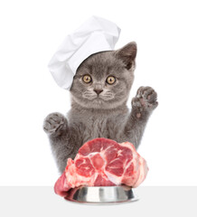 Poster - Hungry cat wearing chef's hat  reads eat piece of raw meat. isolated on white background