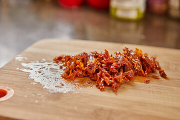 Poster - Sun-dried tomatoes on wooden board, ready for making muffins with sun-dried tomatoes