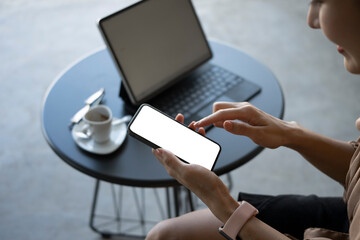 Cropped shot of smiling businesswoman using mobile phone.