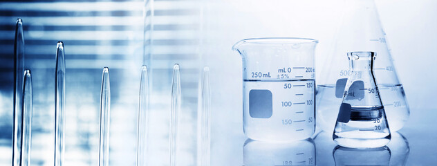 Wall Mural - flask with clear beaker and glassware and pipette tube blue chemistry science lab banner background