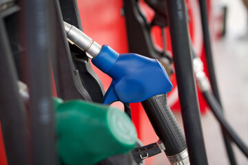 Wall Mural - Closeup blue gas pump nozzle in gas station.