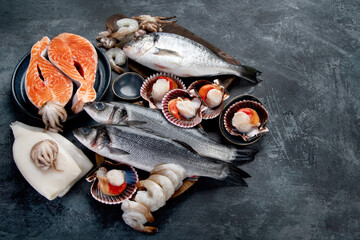 Seafood variety on dark background. Healthy diet eating concept.