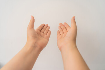 two open empty female hands with palms up, holding something, isolated on white background