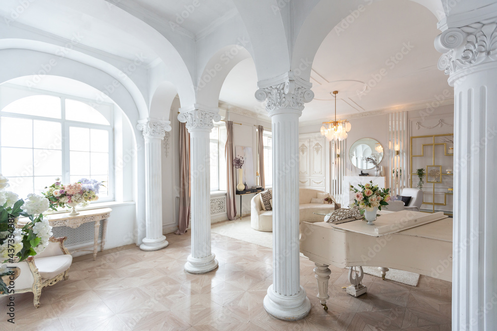rich luxurious interior of a cozy room with modern stylish furniture nd grand piano, decorated with baroque columns and stucco on the walls - obrazy, fototapety, plakaty 