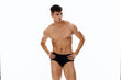 © SHOTPRIME STUDIO - handsome man with naked muscular body in dark panties cropped view