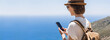 © kite_rin - Tourist woman using mobile phone by the sea panoramic banner