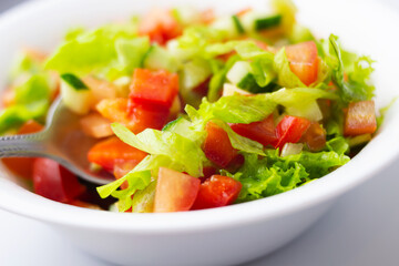 Wall Mural - vegetable salad in a white plate