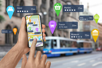 Tourist using online guide application on smartphone for navigation in city, closeup