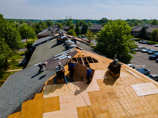 Wall Mural - Roof shingles need with new shingles of an apartment building replacing gray asphalt tile