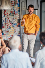 Wall Mural - A young businessman is talking to his colleagues during a presentation at workplace. Business, office, job