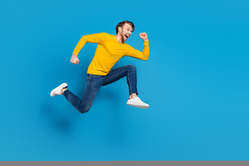 Poster - Full length side profile body size of young guy jumping high running on sale isolated vivid blue color background