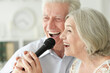 © aletia2011 - Senior couple singing karaoke