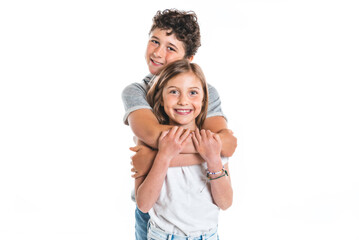 Portrait of cute girl and boy on studio white background