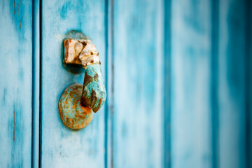 Wall Mural - Weathered knocker on blue wooden door in Algarve, Portuga