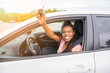 © Louis-Photo - Young black teenage driver seated in her new car