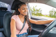 © Louis-Photo - Young black teenage driver seated in her new car