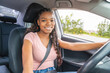 © Louis-Photo - Young black teenage driver seated in her new car