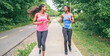 © Louis-Photo - Mother and teen daughter running in green park in summer time