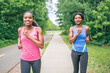 © Louis-Photo - Mother and teen daughter running in green park in summer time