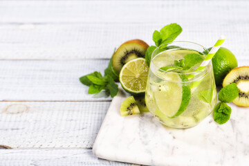 Wall Mural - A glass of mojito cocktail with lime and mint and kiwi