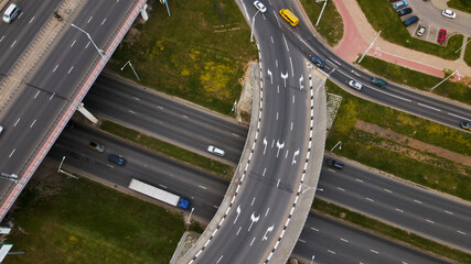 Flight over a multi-level road junction. Public transport is visible. City aerial photography.