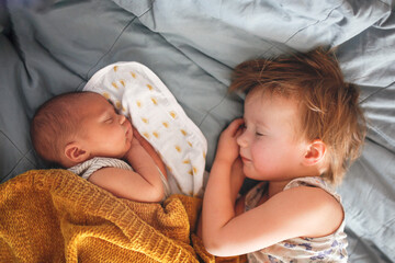 cute baby siblings sleep together, newborn baby and toddler older sister, sibling relationship in th