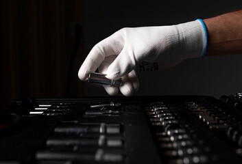 Wall Mural - Male hand close up in white glove over open toolkit with metal tools for car and home repair, head.