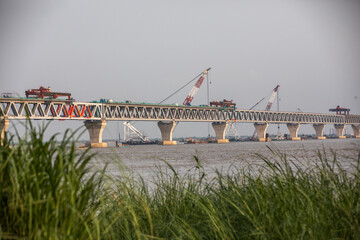 Wall Mural - Construction work on the Padma multipurpose bridge is seen in Louhajang about 40 kilometers from Dhaka on June 4, 2021.