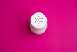 salt or pepper shaker from the top point of view. seasoning powder container in white. food condiment shaker on pink background.