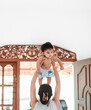 Mom holding her baby girl up in the air over her mother's head, 4 months old daughter's celebration photoshoot.