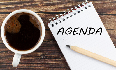 Poster - AGENDA text on notebook with coffee on wooden background