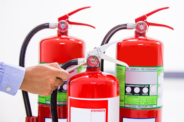 Wall Mural - Fire extinguisher, Firefighter use inspection list checking pressure gauge level of fire extinguisher tank in the building of protection and prevent for emergency and safety rescue and fire training.