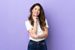 © luismolinero - Woman over isolated purple background thinking an idea while looking up
