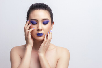 Wall Mural - Makeup Asian woman close eyes show blue color eyeshadow with extreme long false eyelashes. Eyelash Extensions. Makeup, Cosmetics, Beautiful cosmetics makeup concept.