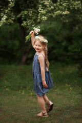 a girl with a bouquet of daisies and a daisy wreath on her head