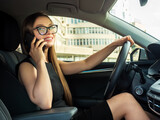 Fototapeta Do przedpokoju - Modern beautiful woman businesswoman talking on the phone in her car.