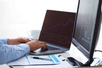 Poster - close-up young businessman statistic graph of stock market financial indices analysis on a laptop an