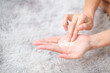 Close up woman holding talc make up on carpet background, beauty concept.