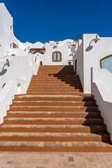 Detail of stairs and white wall of a house on the street of Egypt in Sharm El Sheikh