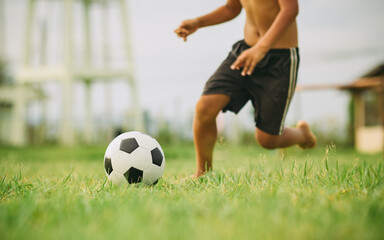 Poster - Action sport outdoors of a group of kids having fun playing soccer football for exercise in community rural area