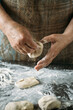 close-up view of hands making delicious pies with dough