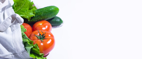 fresh vegetables, lettuce leaves in a shopping bag on a white background. Top view, flat lay. Banner